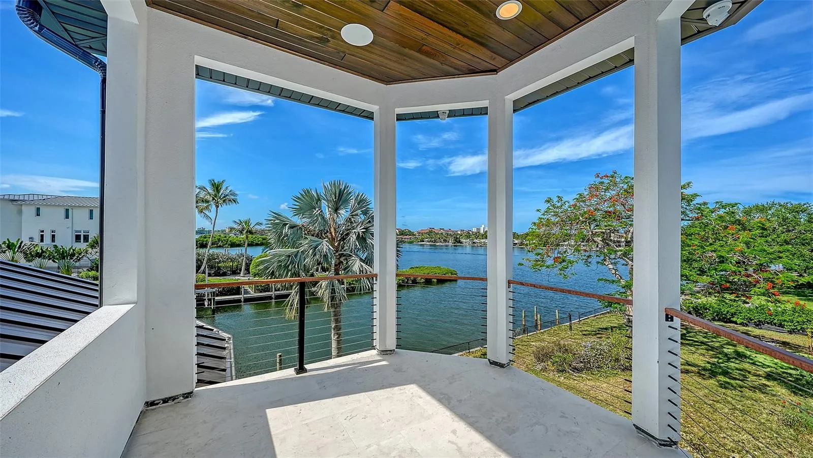 The covered second-story balcony captures sweeping water views and refreshing coastal breezes, offering an exceptional outdoor retreat to relax, entertain, and enjoy Sarasota’s waterfront lifestyle.