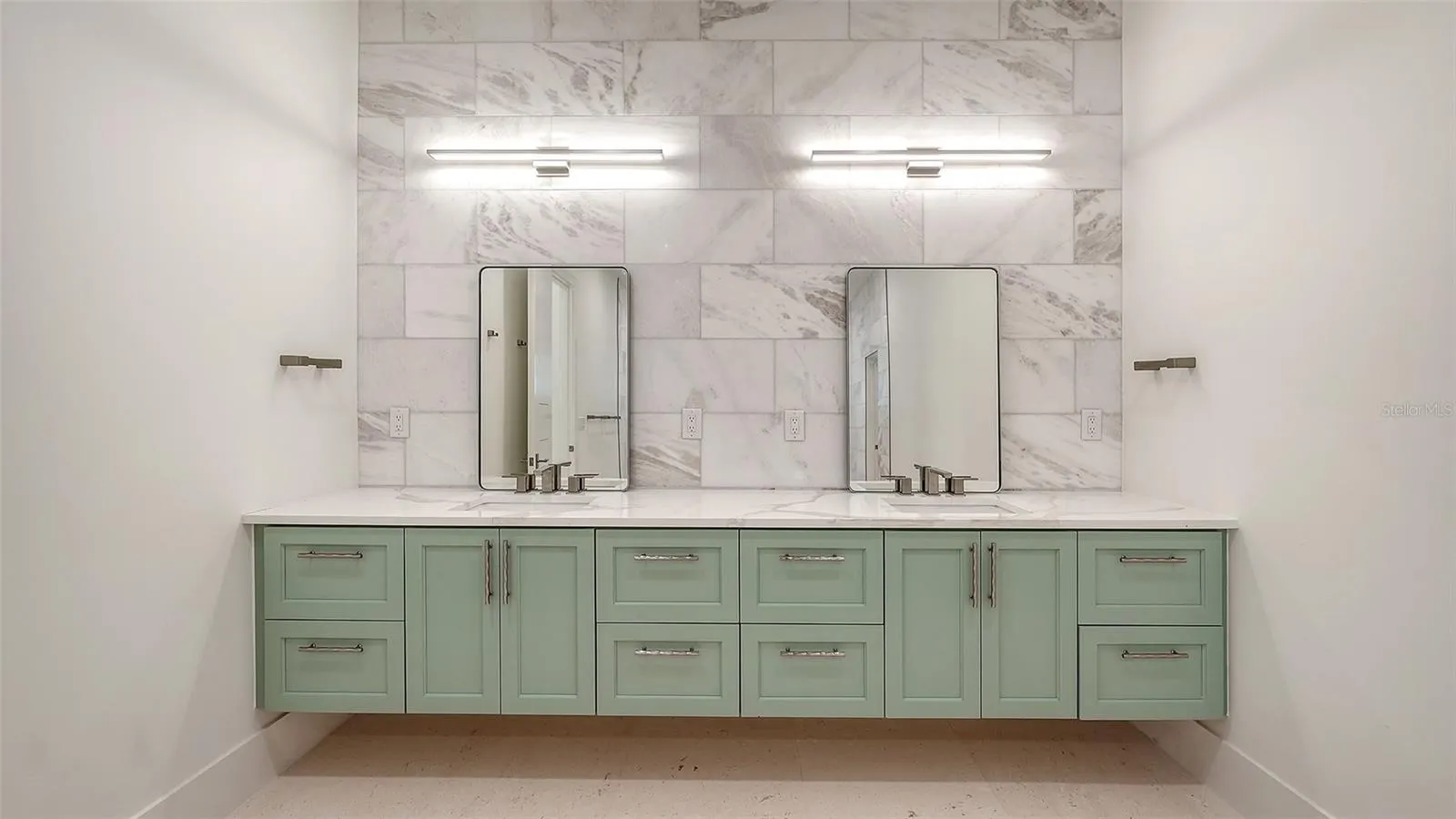 Thoughtfully designed with a floating dual vanity, custom cabinetry, and striking marble details, this elegant space blends beauty with exceptional functionality.