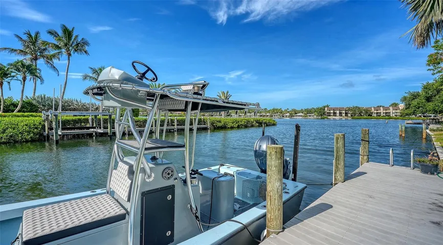 The private dock offers coveted no-bridge access to Sarasota Bay and the Gulf, delivering the effortless waterfront lifestyle that defines luxury coastal living.