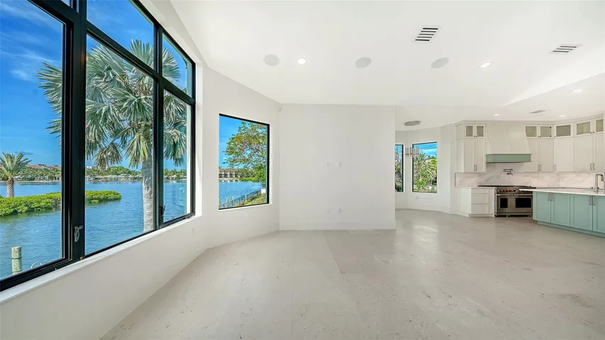 The breakfast area and great room are perfectly positioned to maximize stunning waterfront views, creating an inviting gathering space where natural light and coastal beauty take center stage.