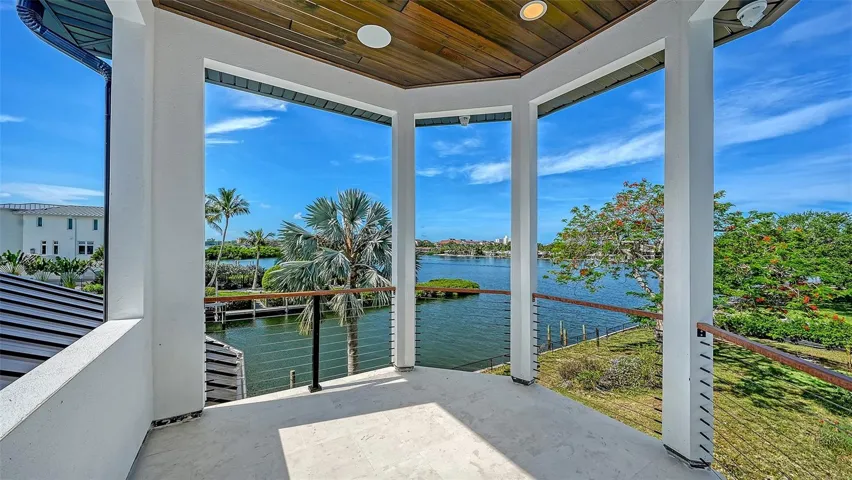 The covered second-story balcony captures sweeping water views and refreshing coastal breezes, offering an exceptional outdoor retreat to relax, entertain, and enjoy Sarasota’s waterfront lifestyle.