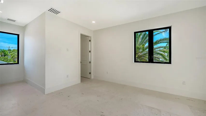 The private second primary suite offers an adjoining sitting area, an expansive walk-in closet, and a beautifully appointed en-suite bath, creating a luxurious retreat for family or guests.