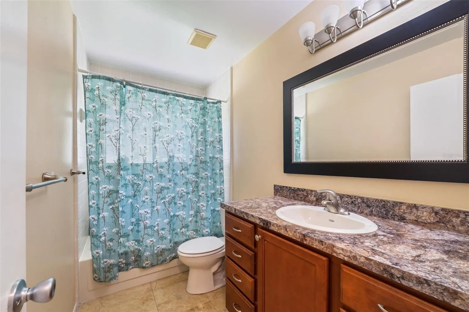 Guest bathroom with decorative mirror