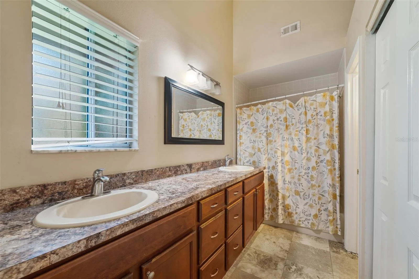 Primary bath has 2 sinks and a closet