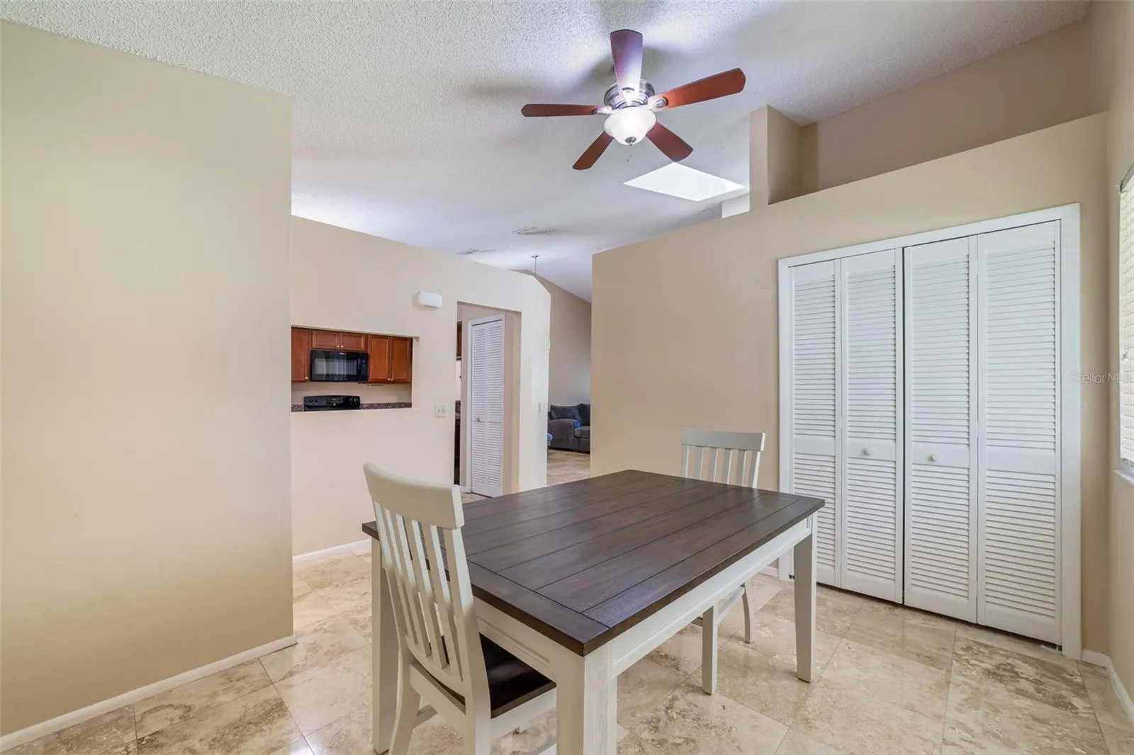 The formal dining room has a ceiling fan PLUS a 3RD storage closet for all of your storage needs!