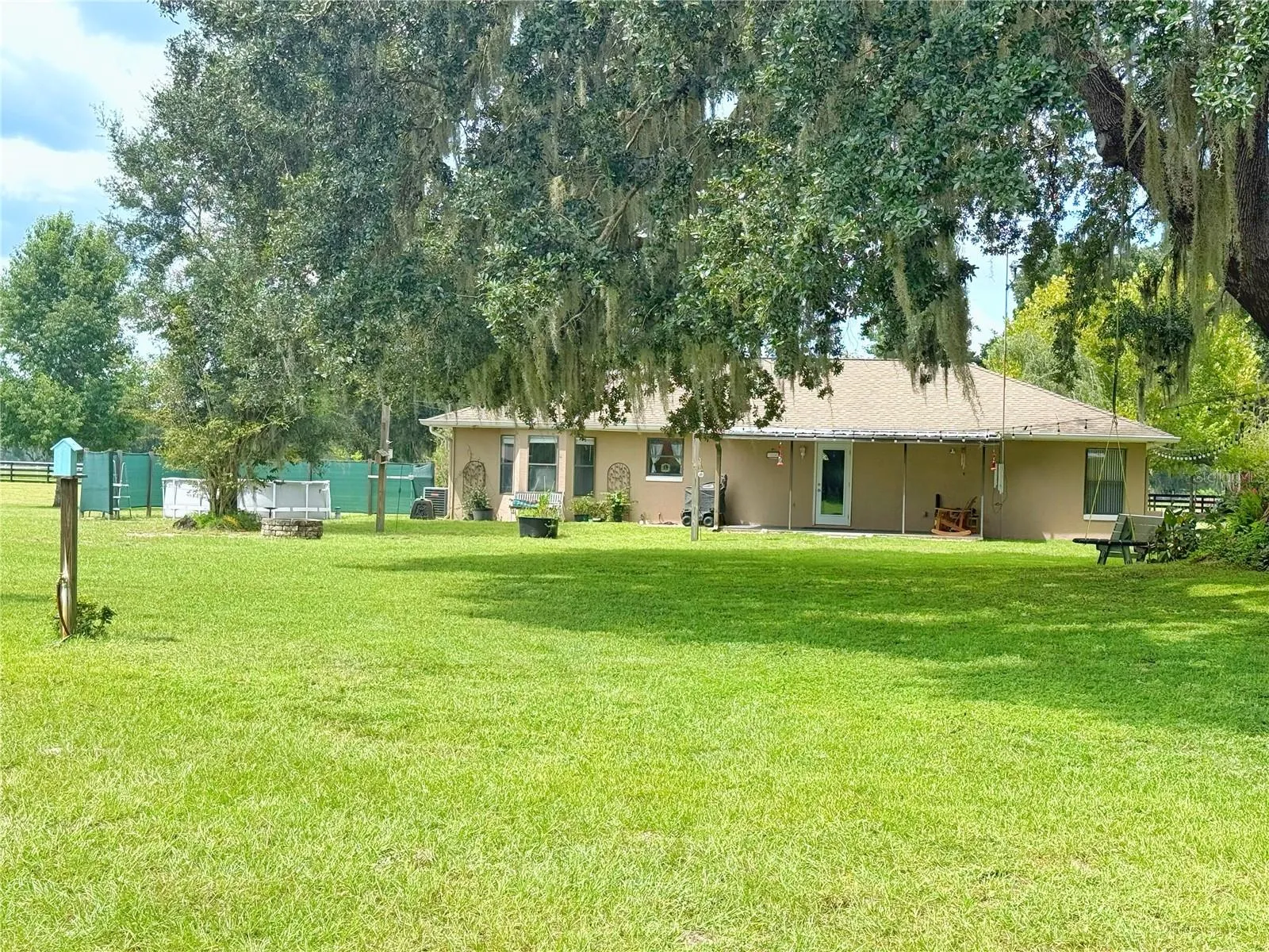 Rear view of the Main house with canopy trees in rear yard