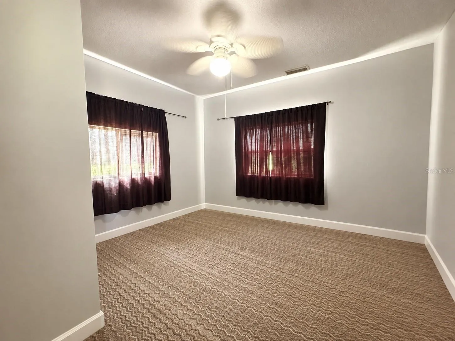 Second home- Bedroom 1 with carpet flooring