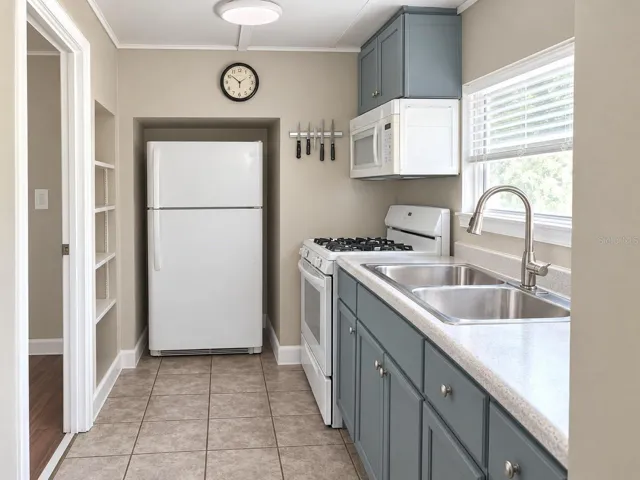 Second home- Kitchen with bathroom door on Left, ceramic tile flooring