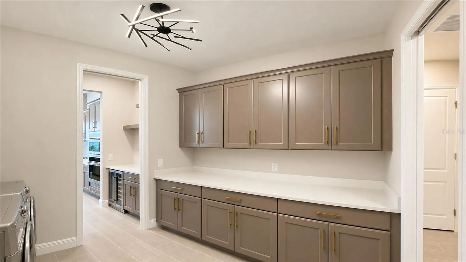 Laundry Room Provides Direct Assess From Mud Room to Butler’s Pantry for Ease &amp; Convenieince