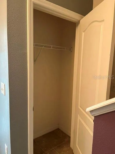 storage closet at the base of the stairs
