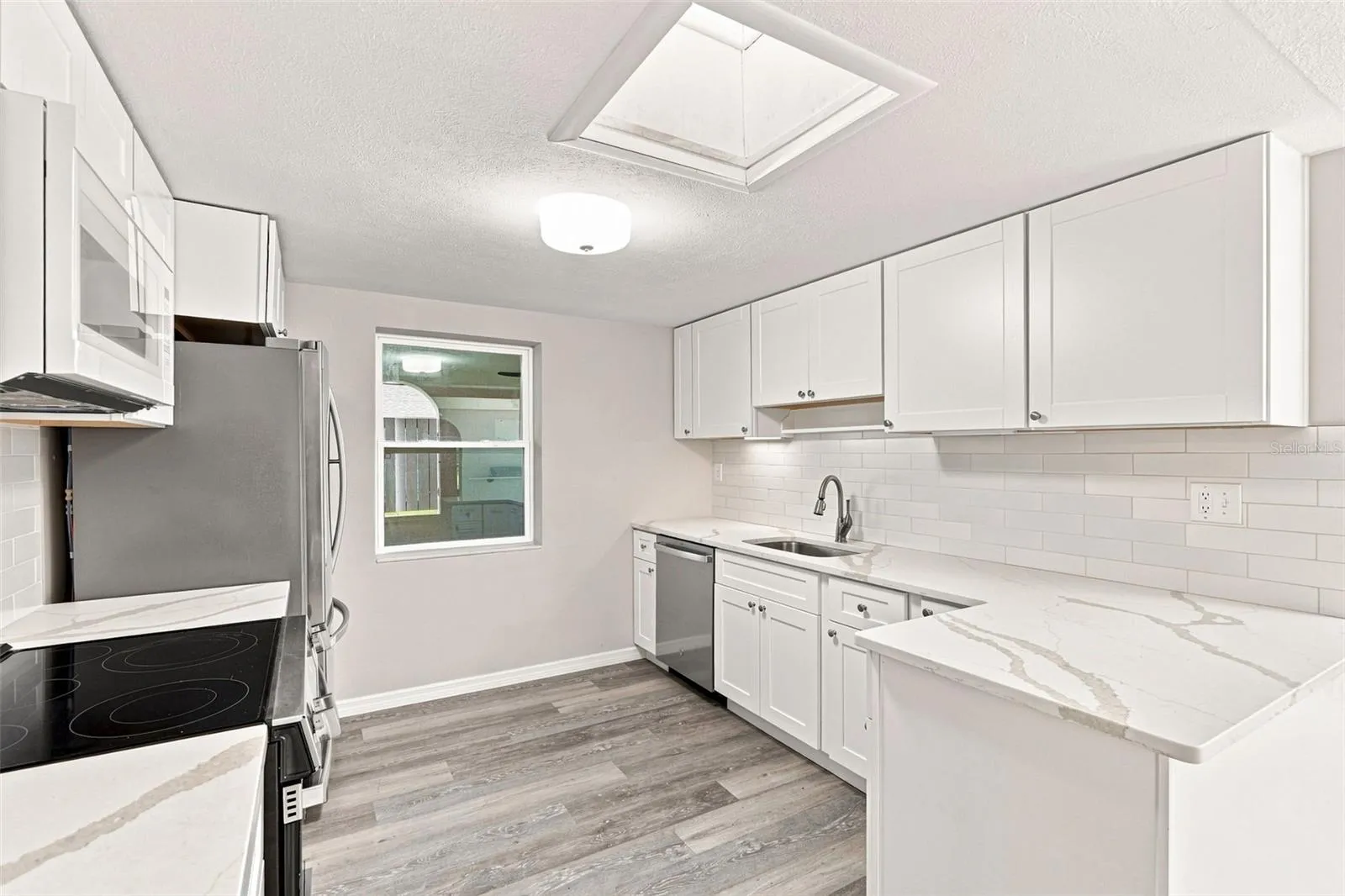 Beautifully Renovated Galley Kitchen with Quartz Countertops