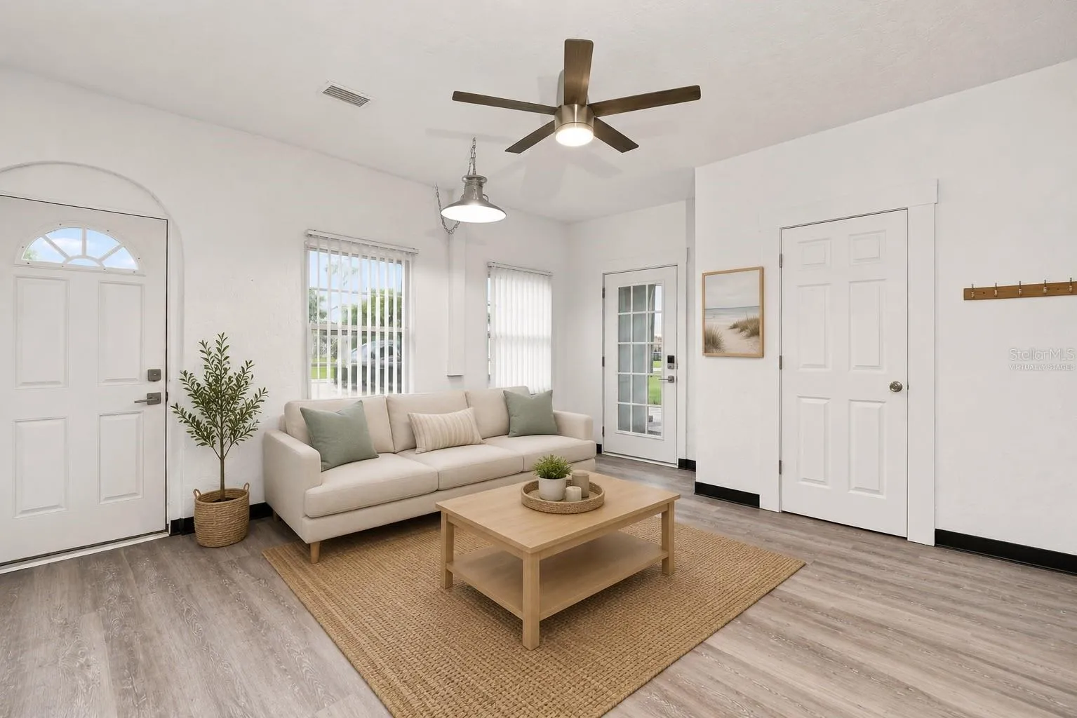 Virtually Staged Bright and Inviting Family Room with with Vaulted Ceilings and New Flooring