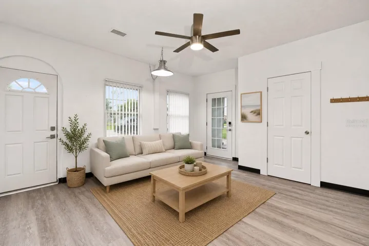 Virtually Staged Bright and Inviting Family Room with with Vaulted Ceilings and New Flooring