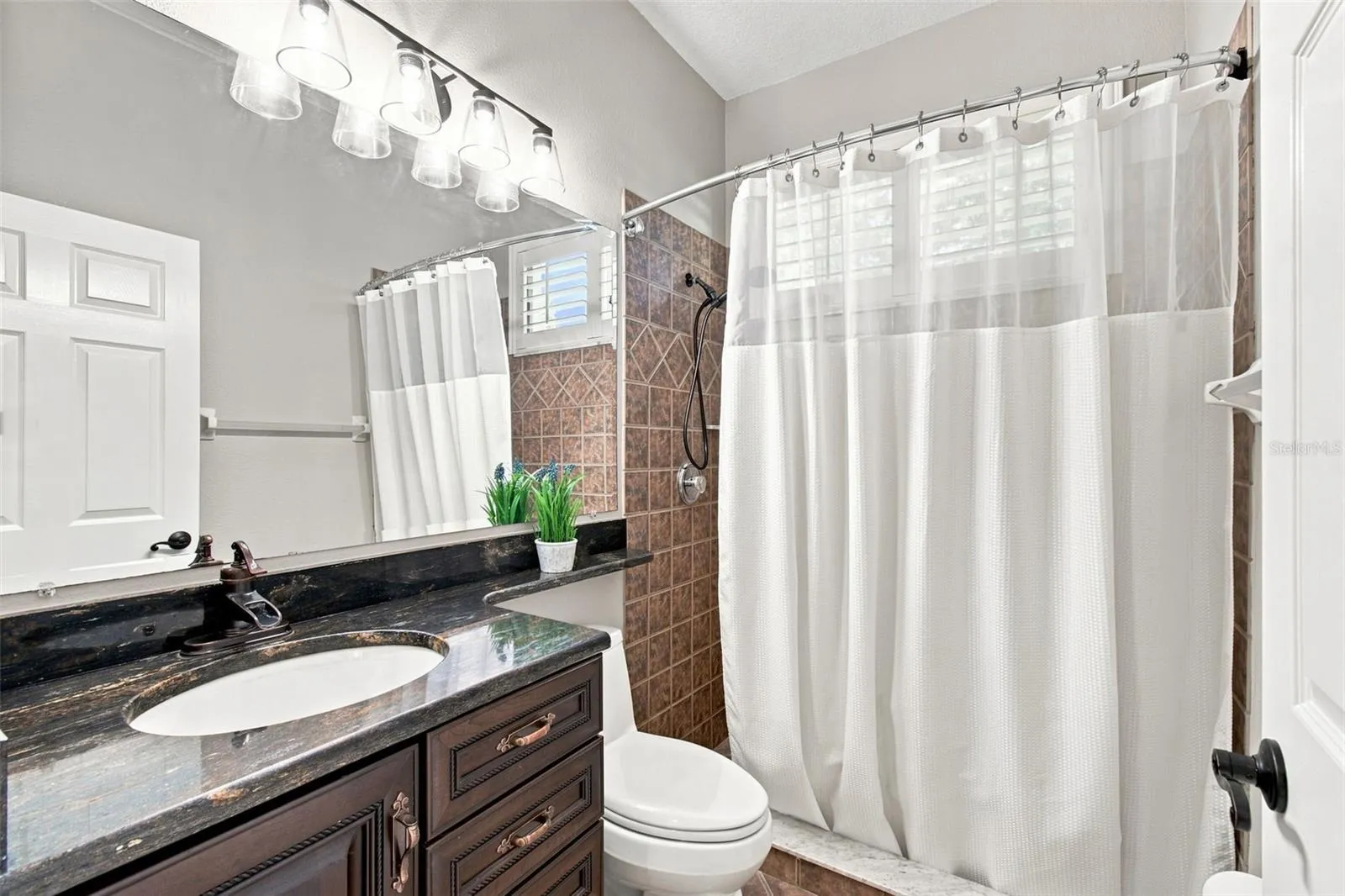 Guest bathroom is the 3rd full bath with updated granite, soft-close cabinet door and drawers, new light fixture and a walk-in shower