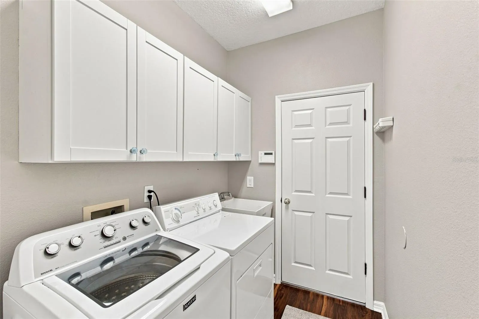 Laundry room a deep utility sink, soft close upper cabinet doors.  Washer and dryer can stay with the home