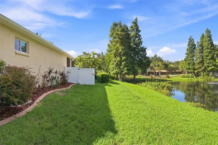 Side yard abutting the pond with fountain that is owned and maintained by the CDD.