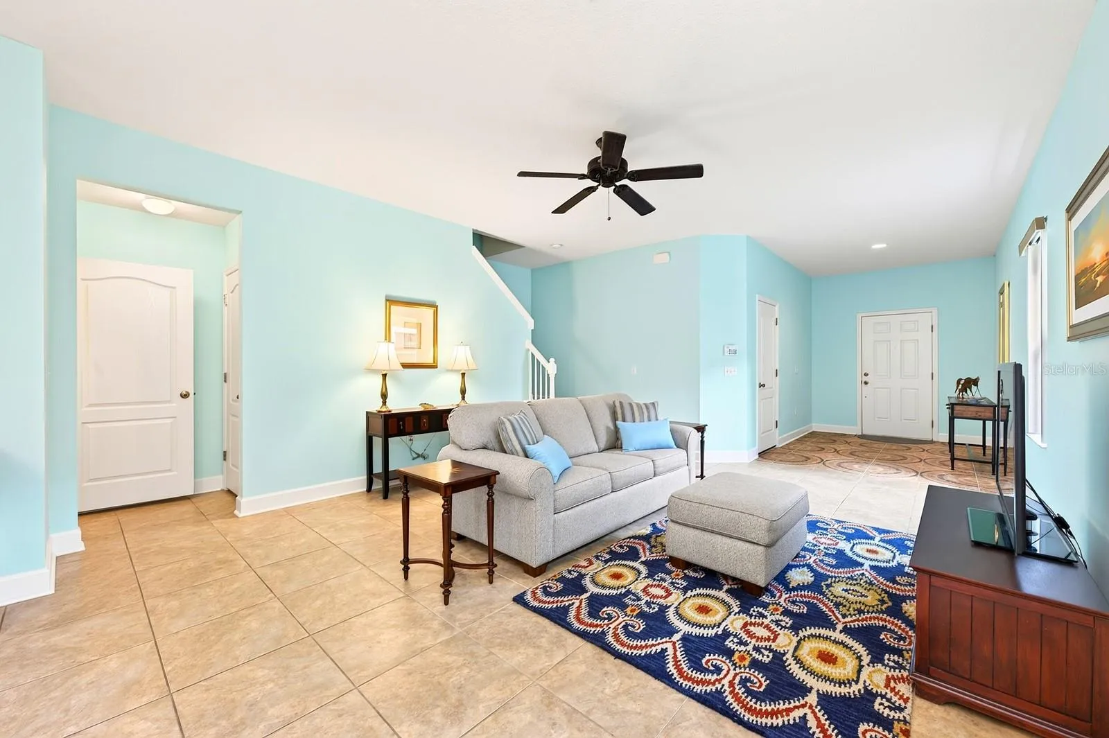 A paver driveway, covered front entry, and attractive curb appeal welcome you inside, where TILE FLOORING throughout the main level and an OPEN CONCEPT layout create a light, bright atmosphere perfect for everyday living.