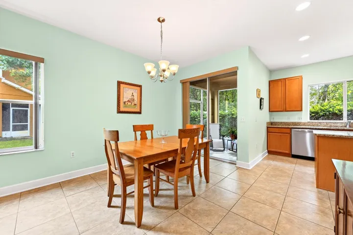 Light filled dining area opens through sliding glass doors to a screened lanai.