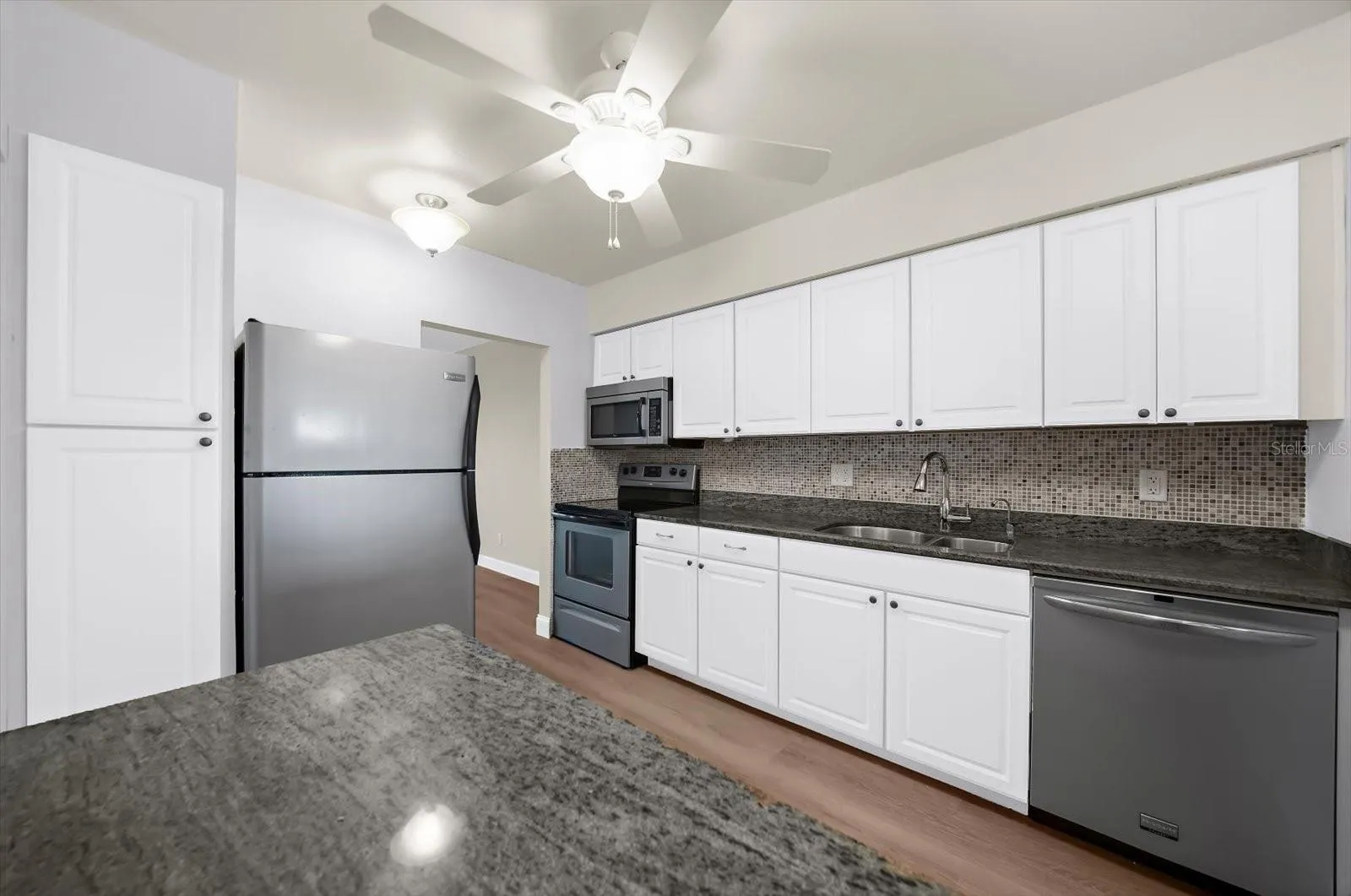 Another view of the kitchen showing the large pantry