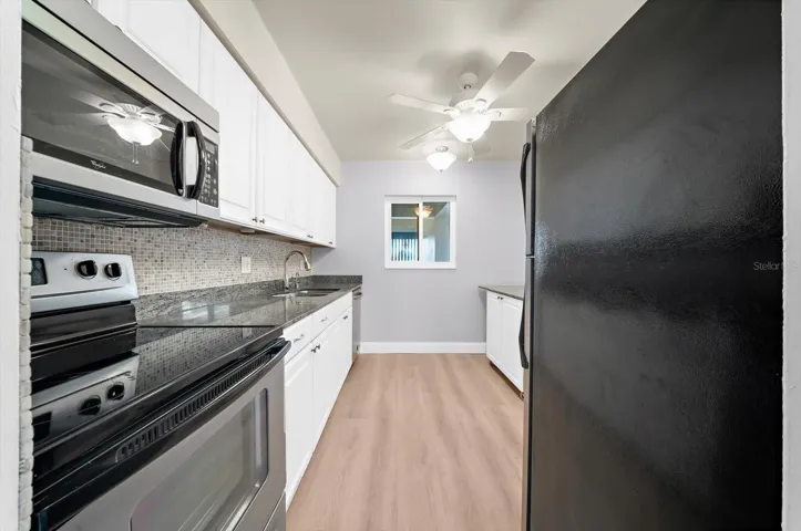 The updated kitchen offers granite counter and stainless steel appliances.