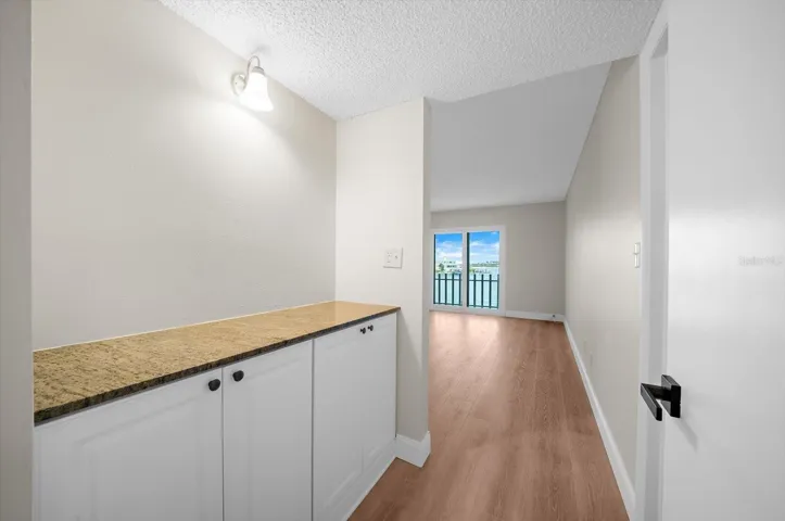 Primary entry with extra storage cabinets.