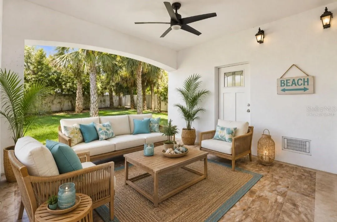 Virtually staged first floor covered porch with access to the backyard