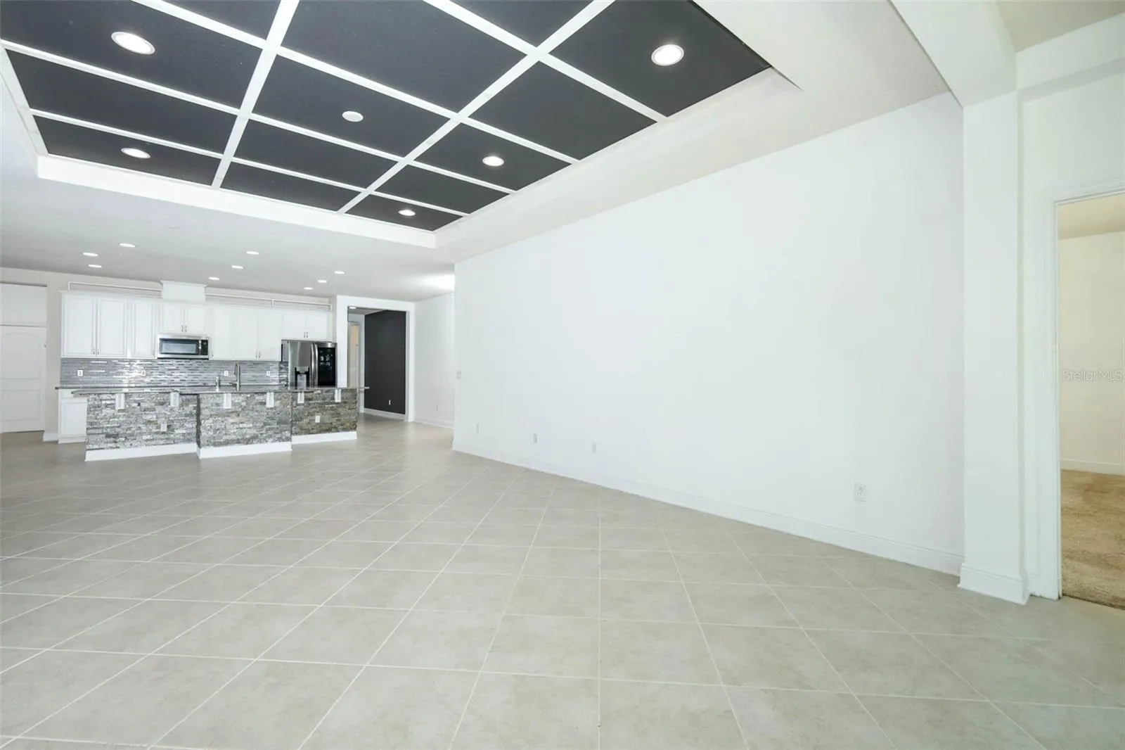 VIEW OF FAMILY ROOM &amp; KITCHEN