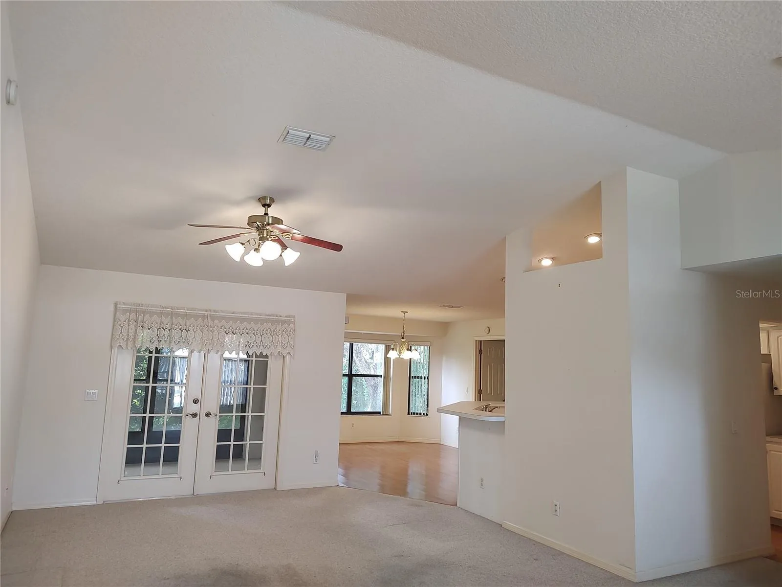 Cathedral ceiling in living room opens to porch