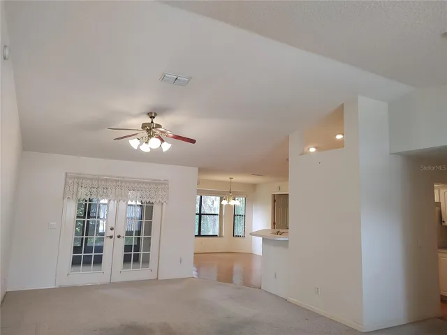 Cathedral ceiling in living room opens to porch