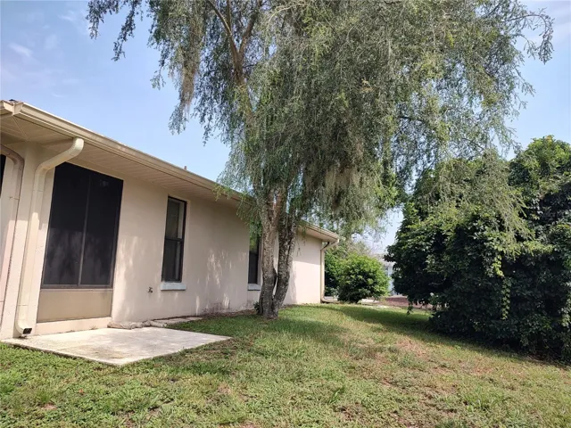 Side yard with pad for potted plants, BBQ?