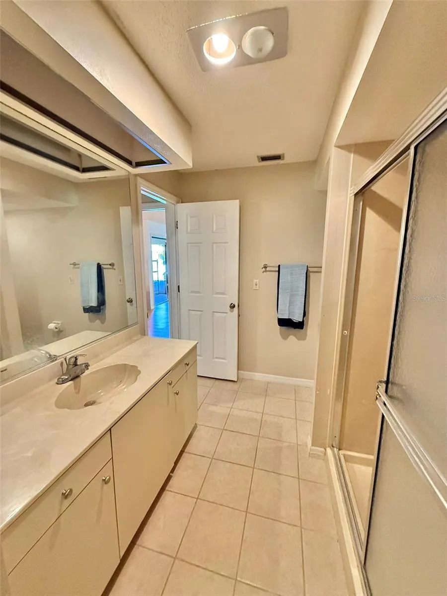Bathroom with shower stall and walk-in closet