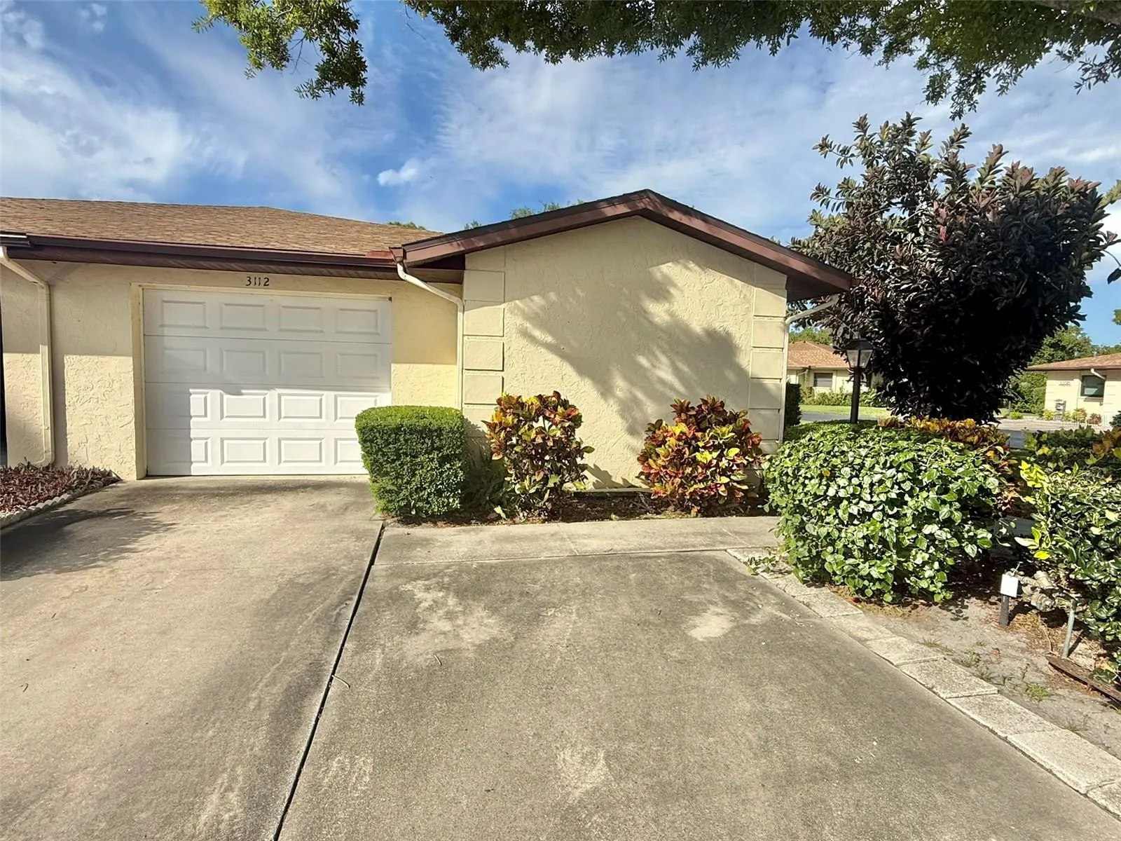Exterior one car garage and double parking pad