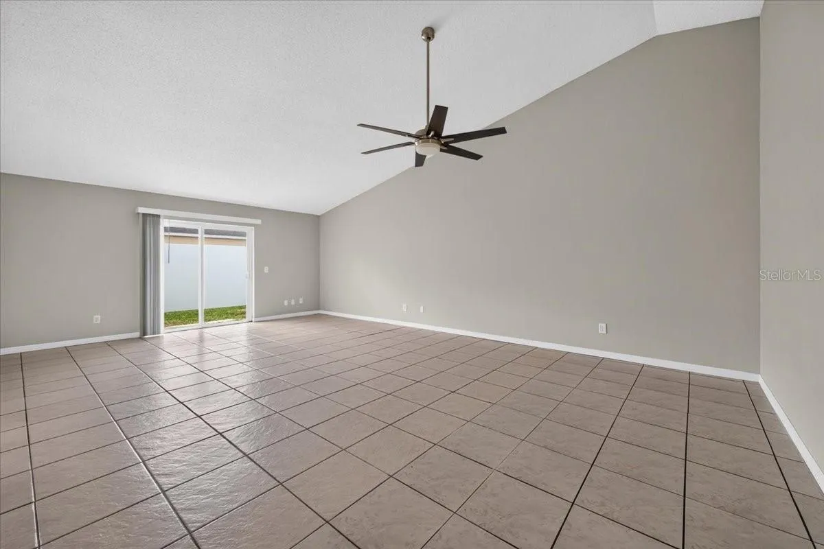 Living room looking at back patio window