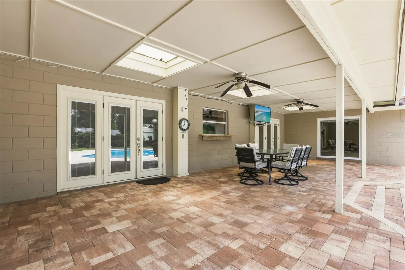 Step outside and discover your own PRIVATE OASIS where a  brick paver patio surrounds a sparkling in-ground pool, creating the perfect place to soak up the Florida sunshine.