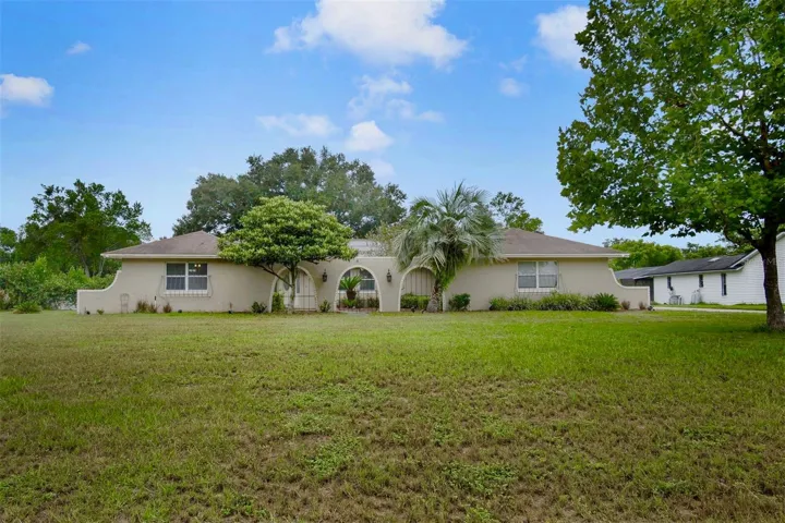 Nestled on an OVERSIZED HOMESITE of well over half an acre in the sought-after Lake Ann Estates of Winter Park.
