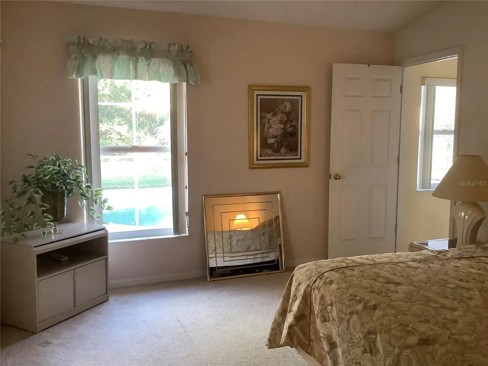 Primary bedroom with window view to pool