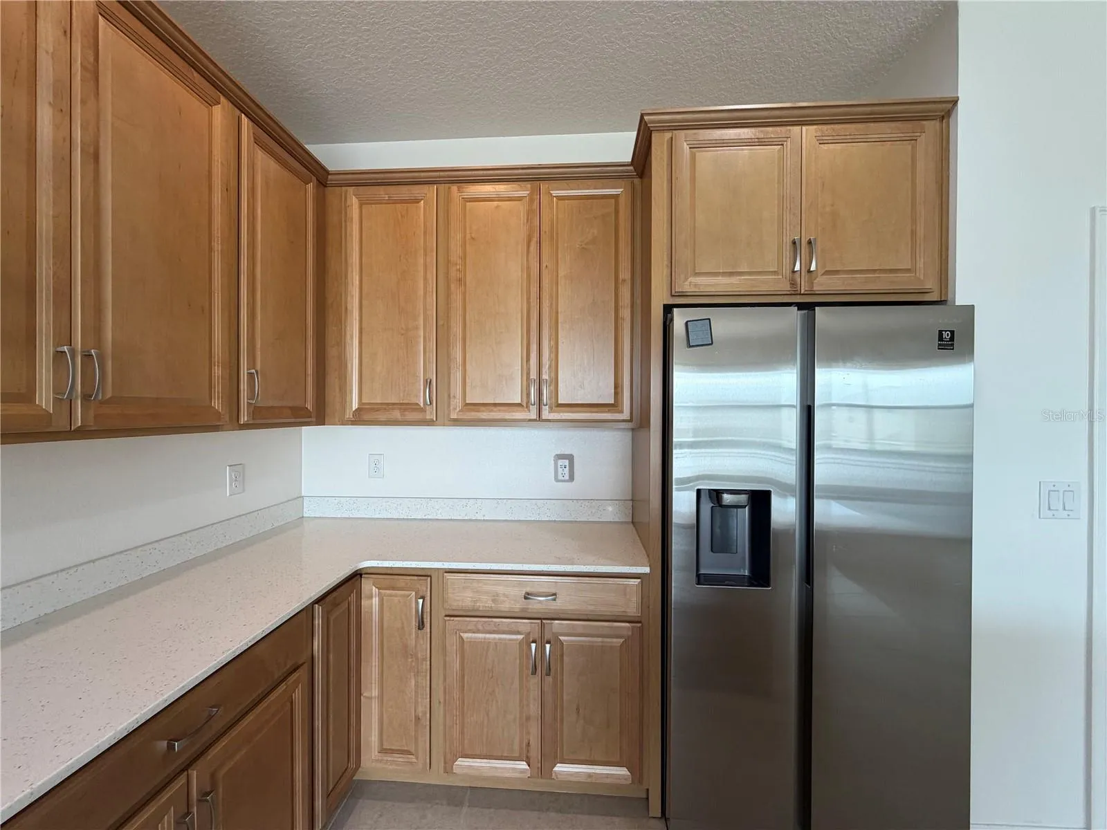 Kitchen with side by side refrigerator