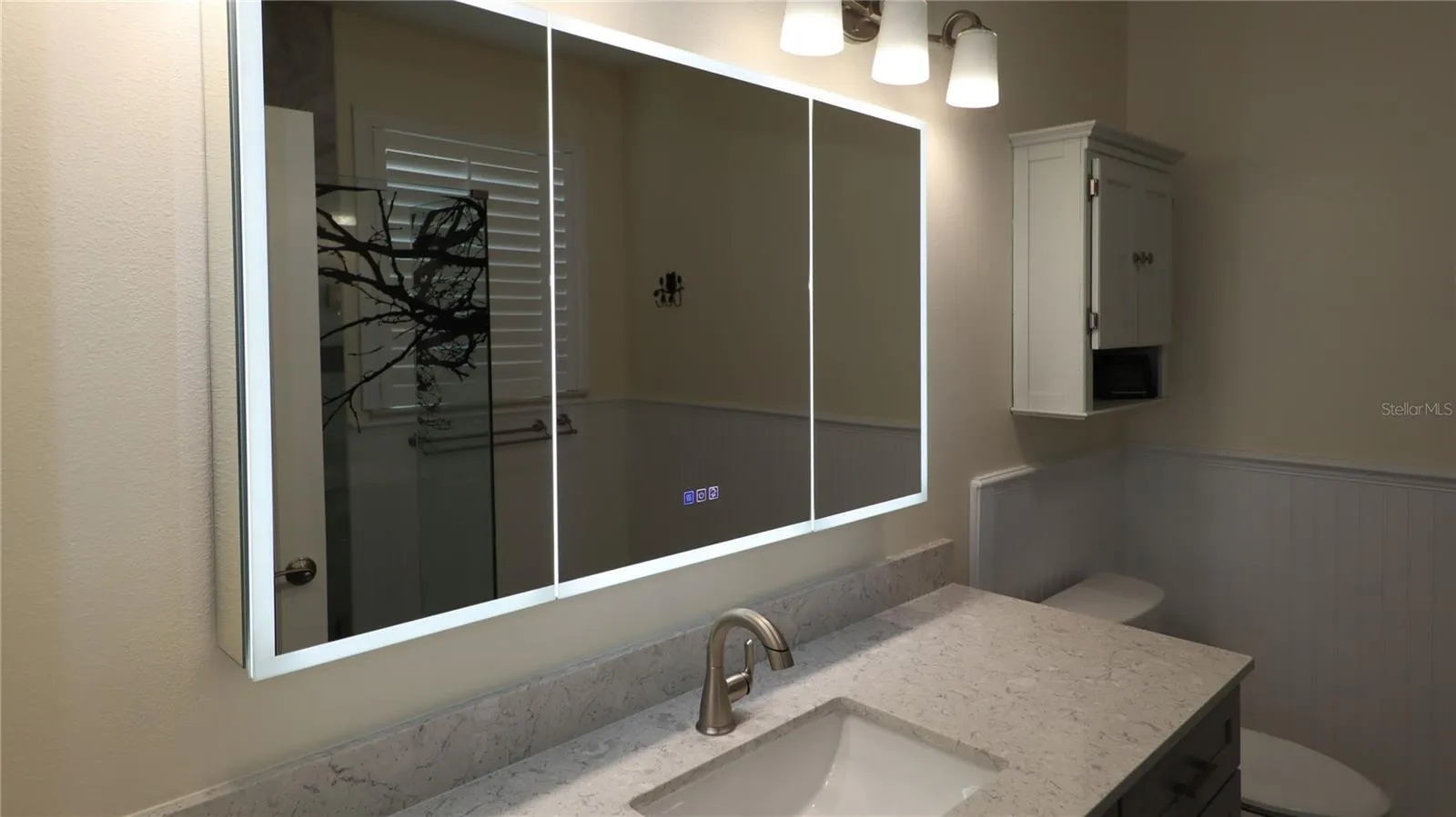 lighted triple mirrored medicine cabinet...