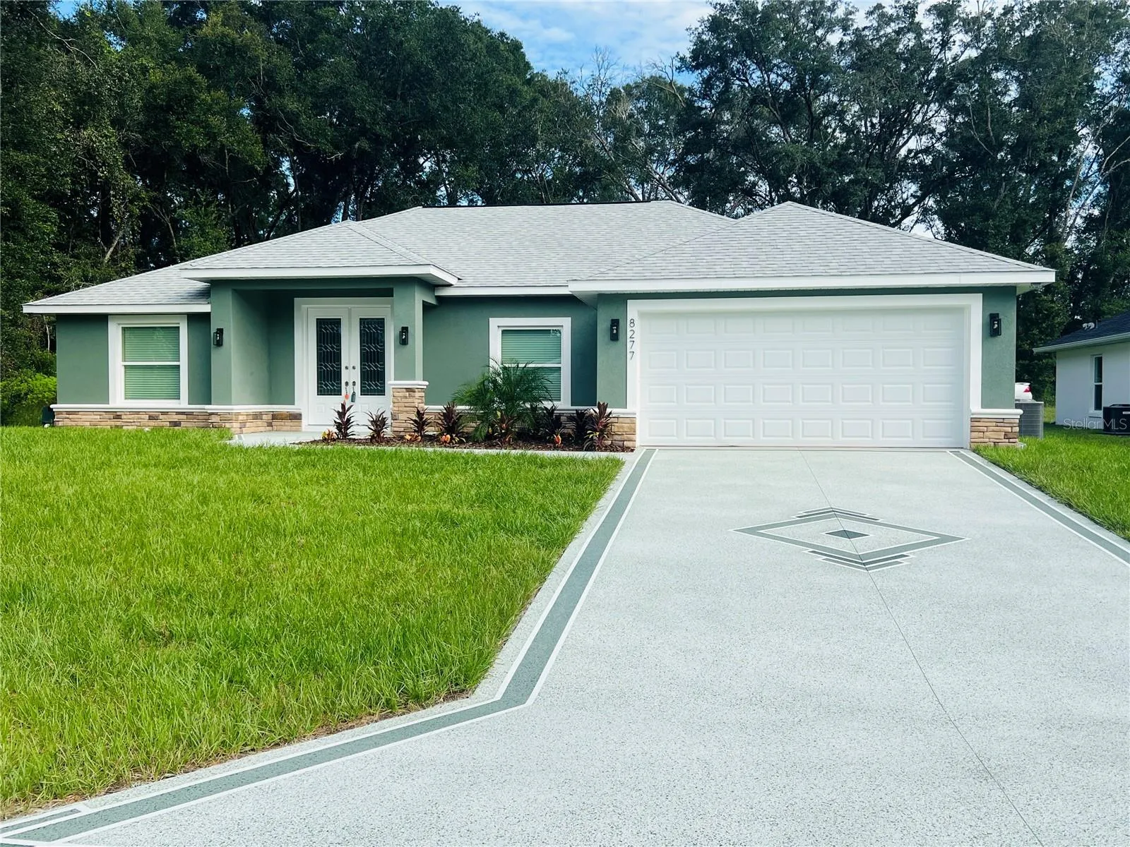 Gorgeous Concrete coating on driveway, walkway and front entrance to enhance the beautiful curb appeal
