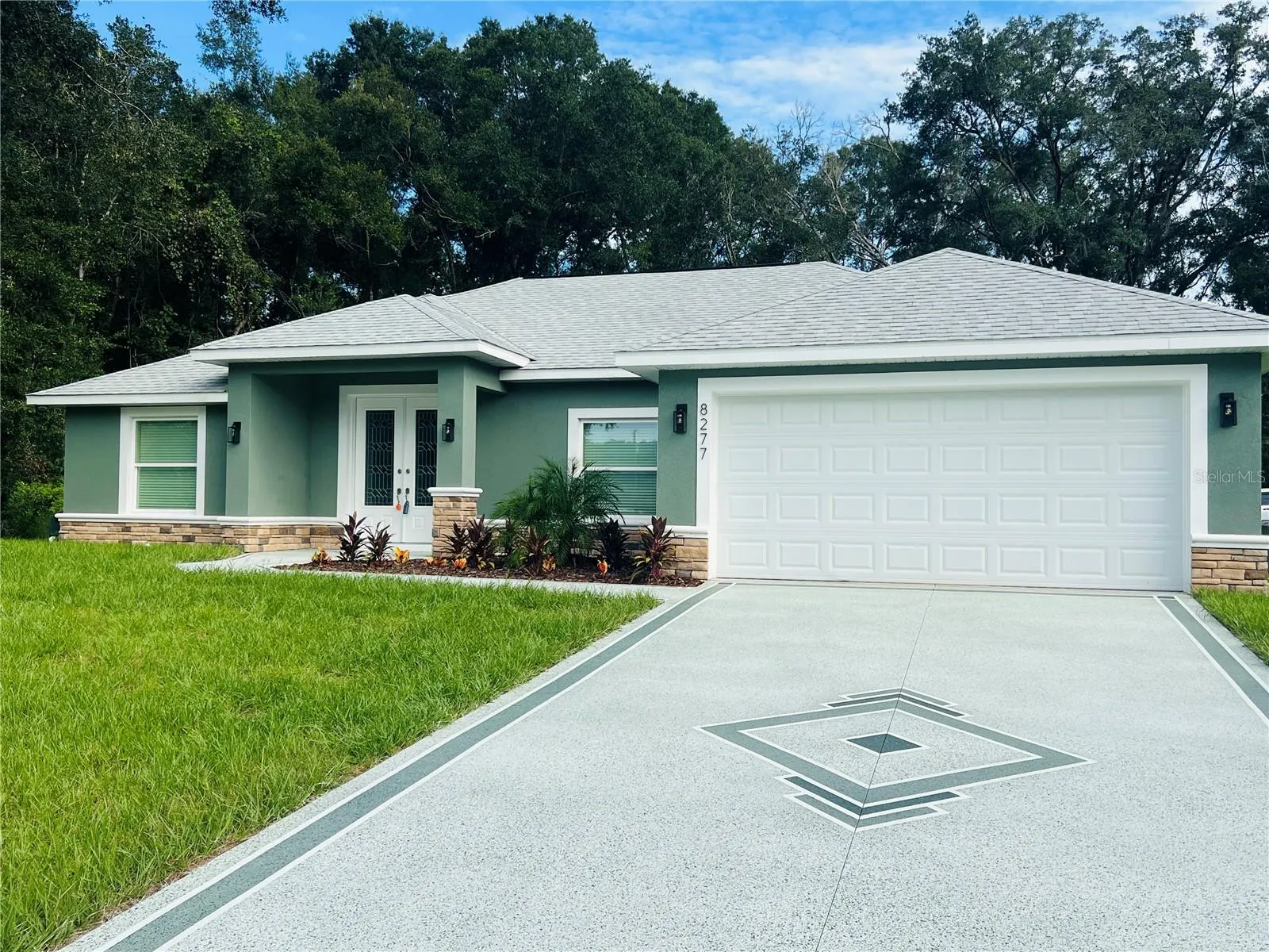 Check out all the extras on this exterior! Concrete design, Huge floating house numbers, real rock accent &amp; nice landscaping.