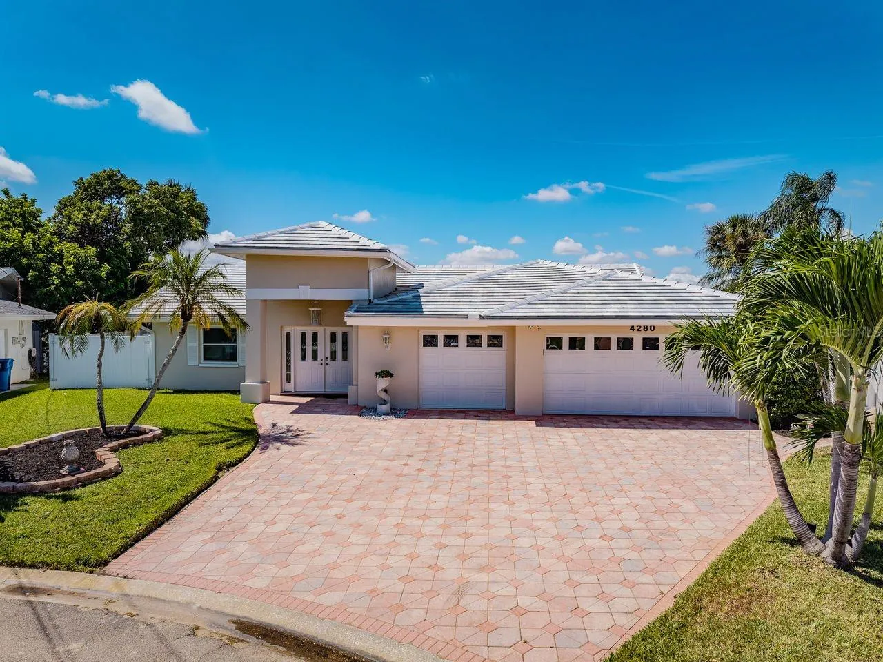 Pretty paver drive highlights this beautiful home