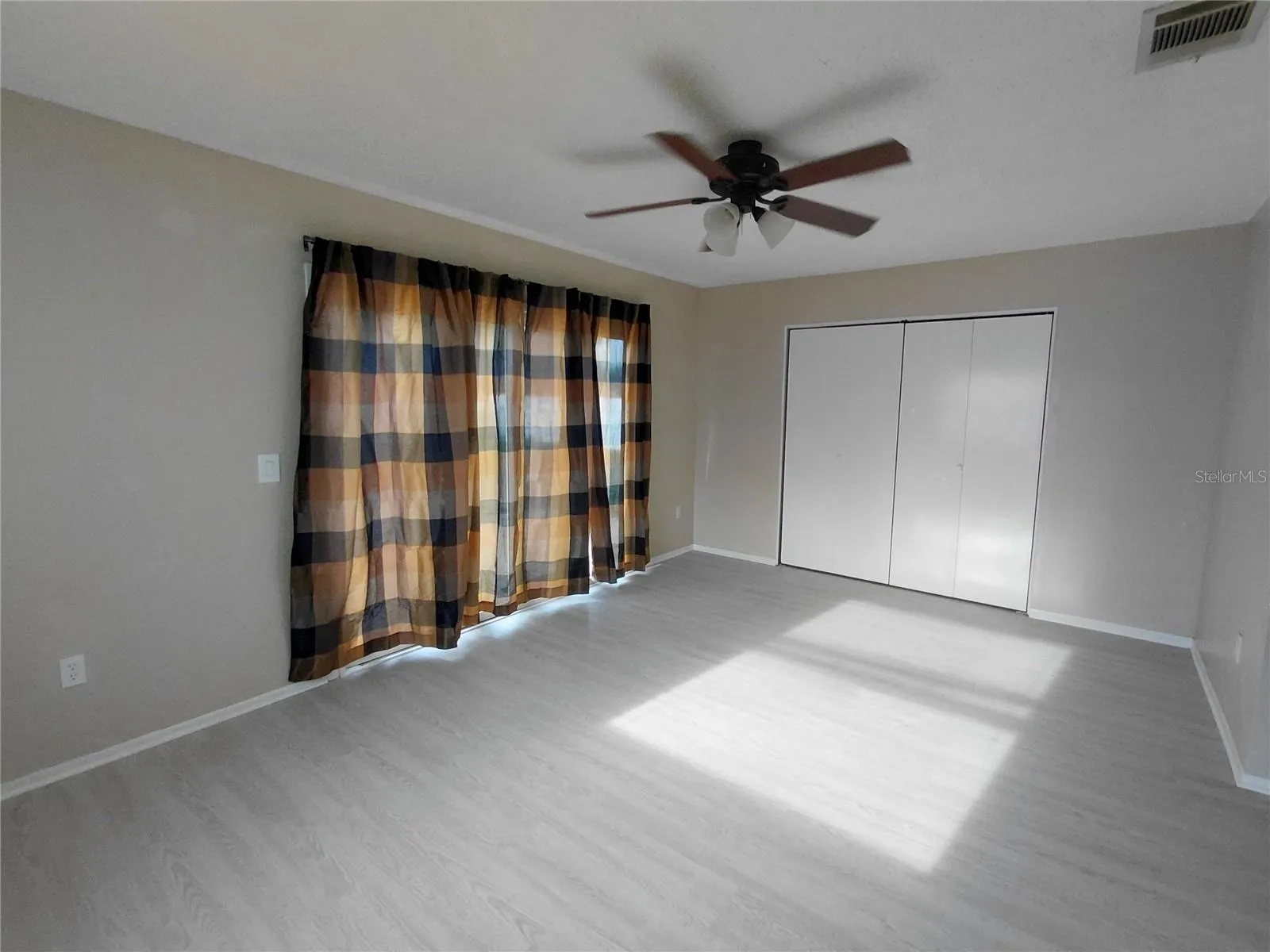 Rear Family Room with sliding doors and storage.