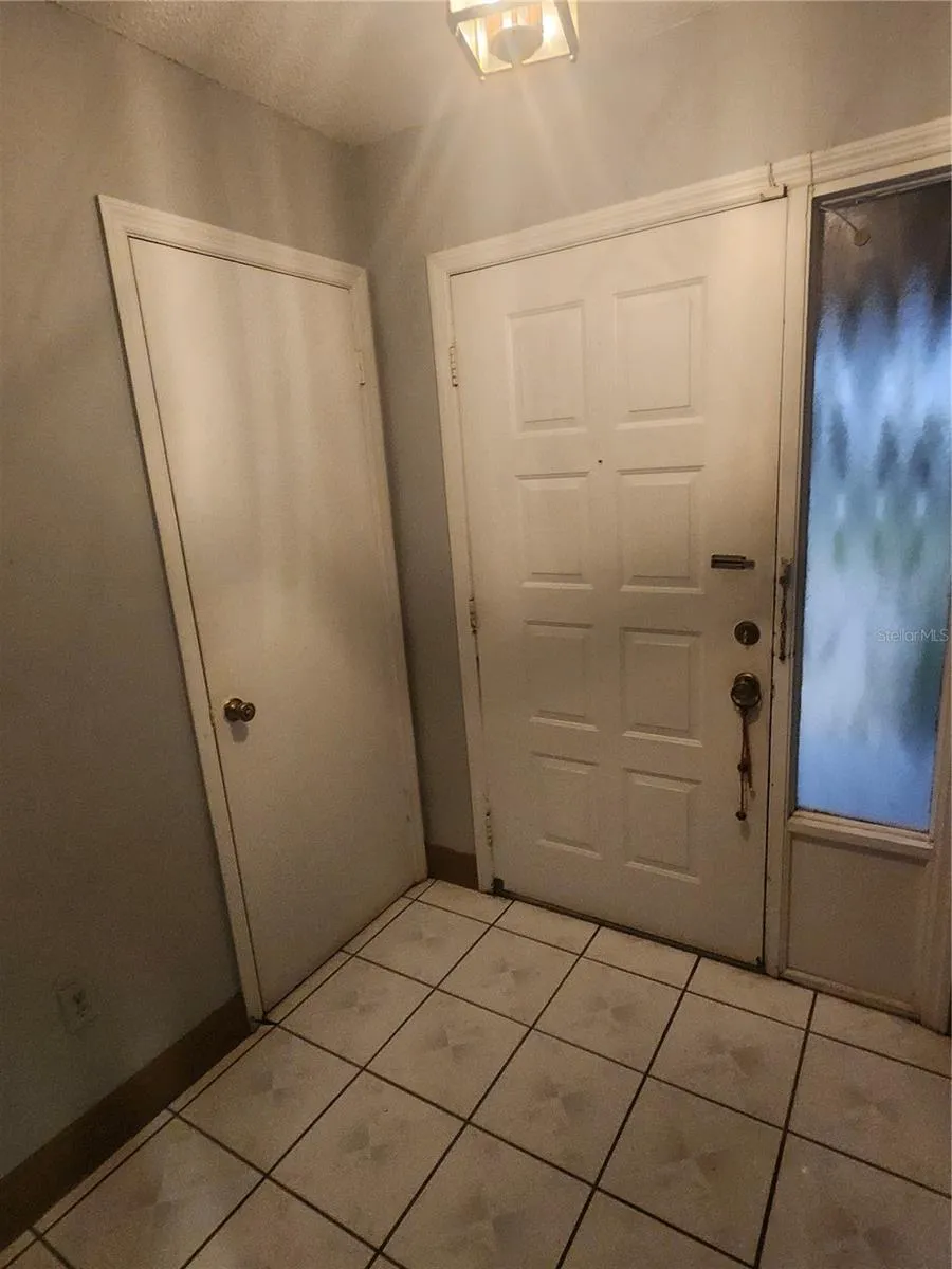 VIEW OF FRONT DOOR AND ENTRY CLOSET