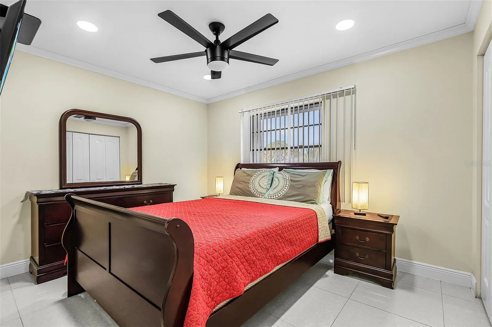 Second guest bedroom with ceiling fan, recessed lighting, and tile flooring.