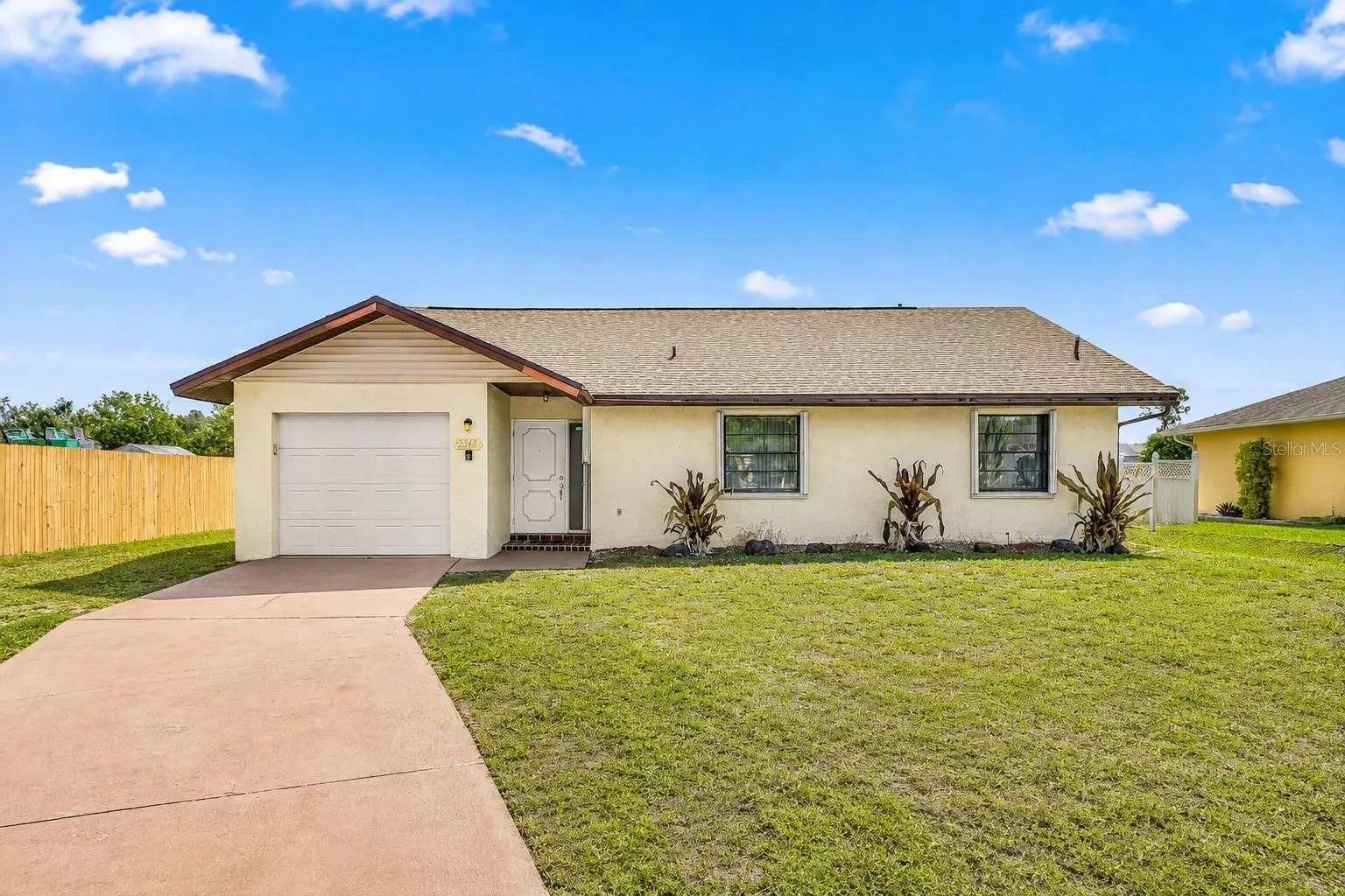 Front exterior of 2368 Pellam Boulevard with attached garage and curved driveway.