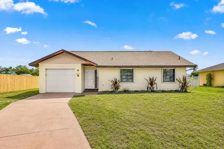 Front exterior of 2368 Pellam Boulevard with attached garage and curved driveway.