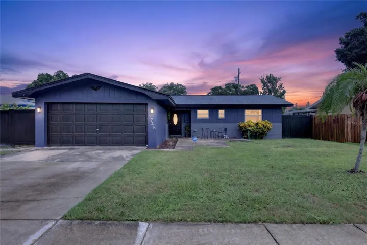 Twilight photo of front of 1748 Greenlea.  Check out the new navy blue paint colors on the exterior.