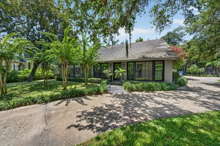 Charming cottage-style home nestled along a prestigious tree-lined street in South Tampa