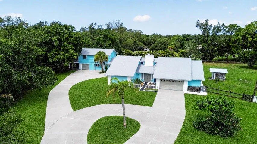 Aerial view of the home, circular drive and grounds.