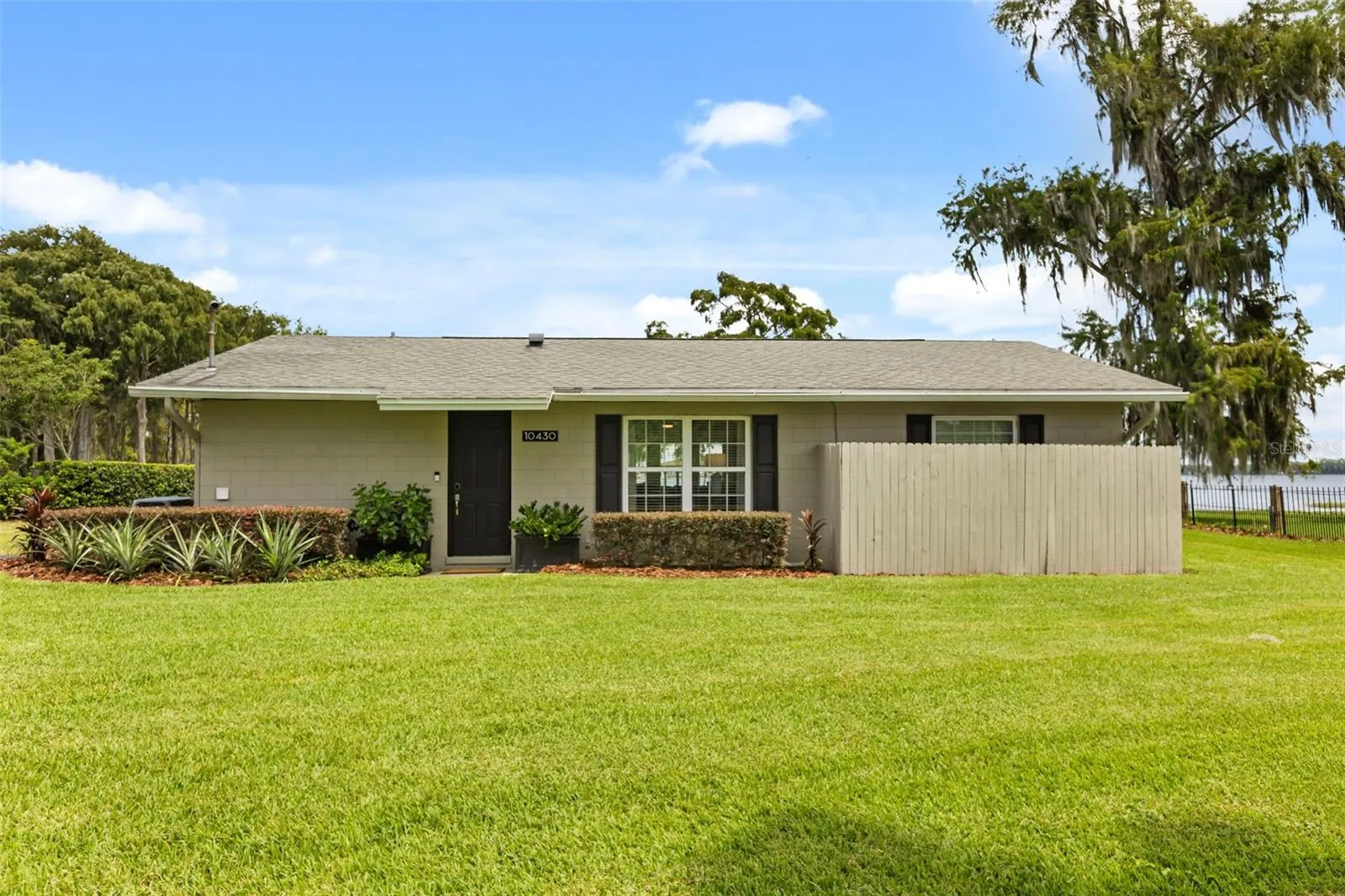 Lake Cottage Lane, featuring an oversized homesite, expansive Lake Sheen views, sandy shoreline, private dock and boatlift, and an existing 2BR/1.5BA lake cottage that can be enjoyed today while you plan the lakefront estate of your dreams.